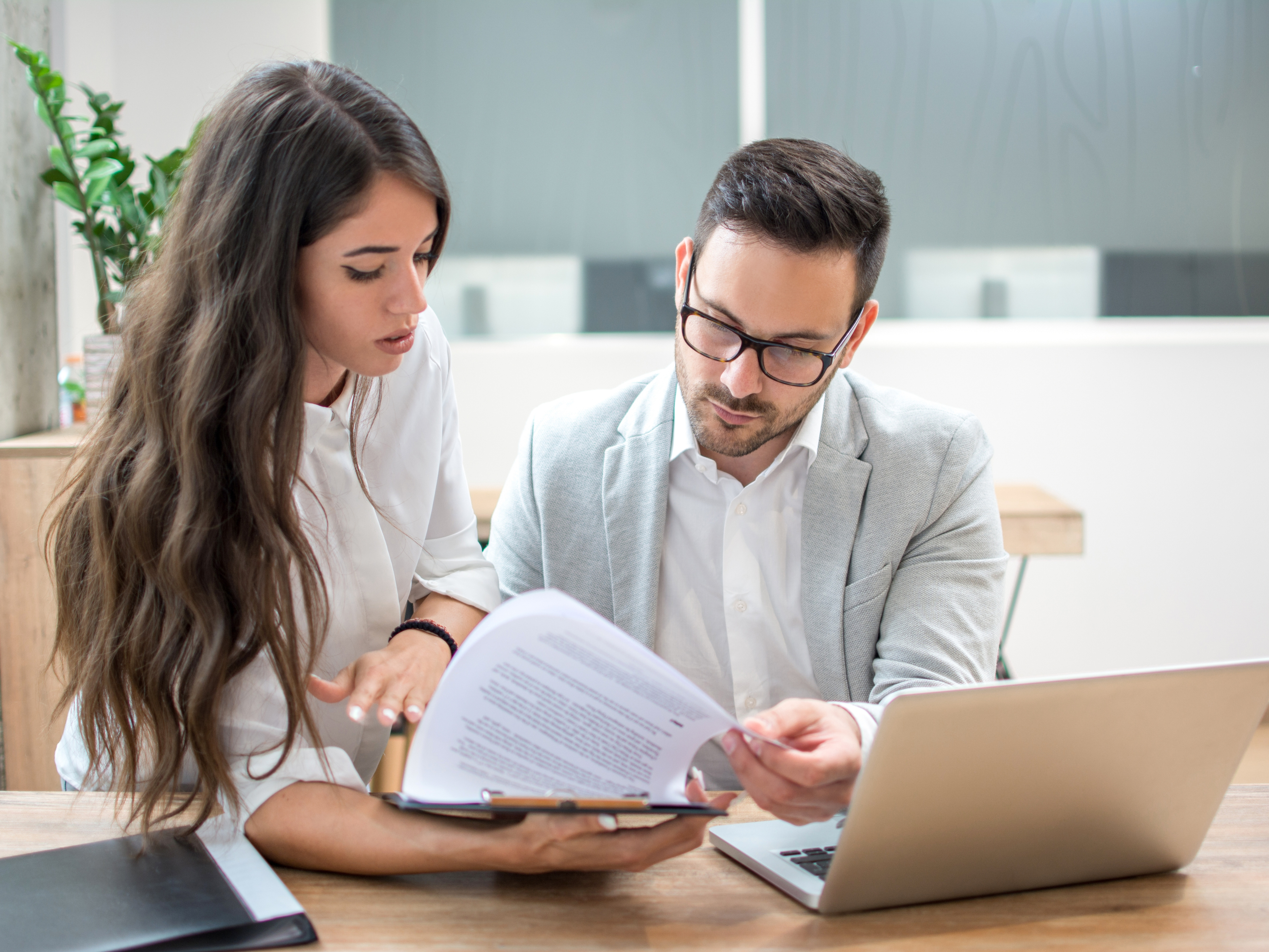 Factory professional reviewing operational documents at a workstation